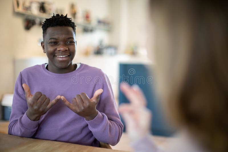 Teenage Boy And Girl Have Conversation Using Sign Language. Teenage Boy And Girl Have Conversation Using Sign Language