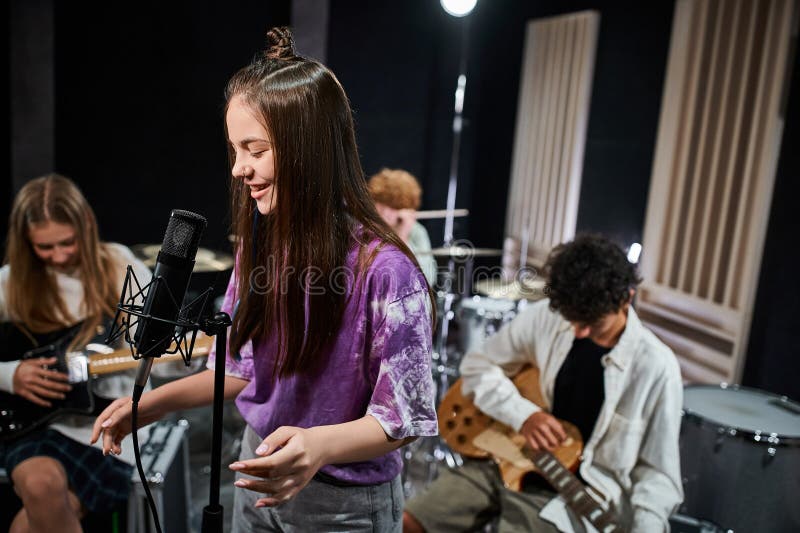 jolly cute teenagers in everyday vivid attires playing instruments and singing actively in studio, stock photo. jolly cute teenagers in everyday vivid attires playing instruments and singing actively in studio, stock photo