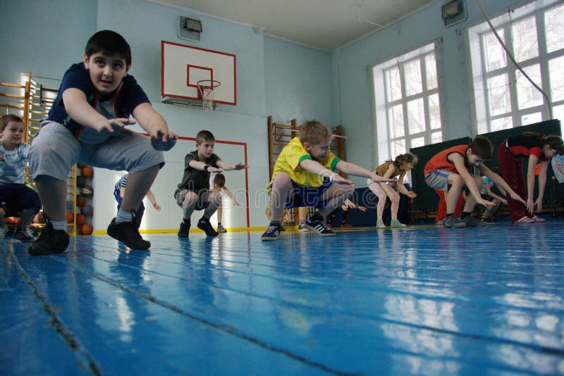 Teenagers at a school in gym class. In Russia, the physical education in school is twice a week. There are children at the beginning of physical education classes when the teacher explains the lesson on the job. February 11, 2009 in the Novosibirsk, Russia. Teenagers at a school in gym class. In Russia, the physical education in school is twice a week. There are children at the beginning of physical education classes when the teacher explains the lesson on the job. February 11, 2009 in the Novosibirsk, Russia