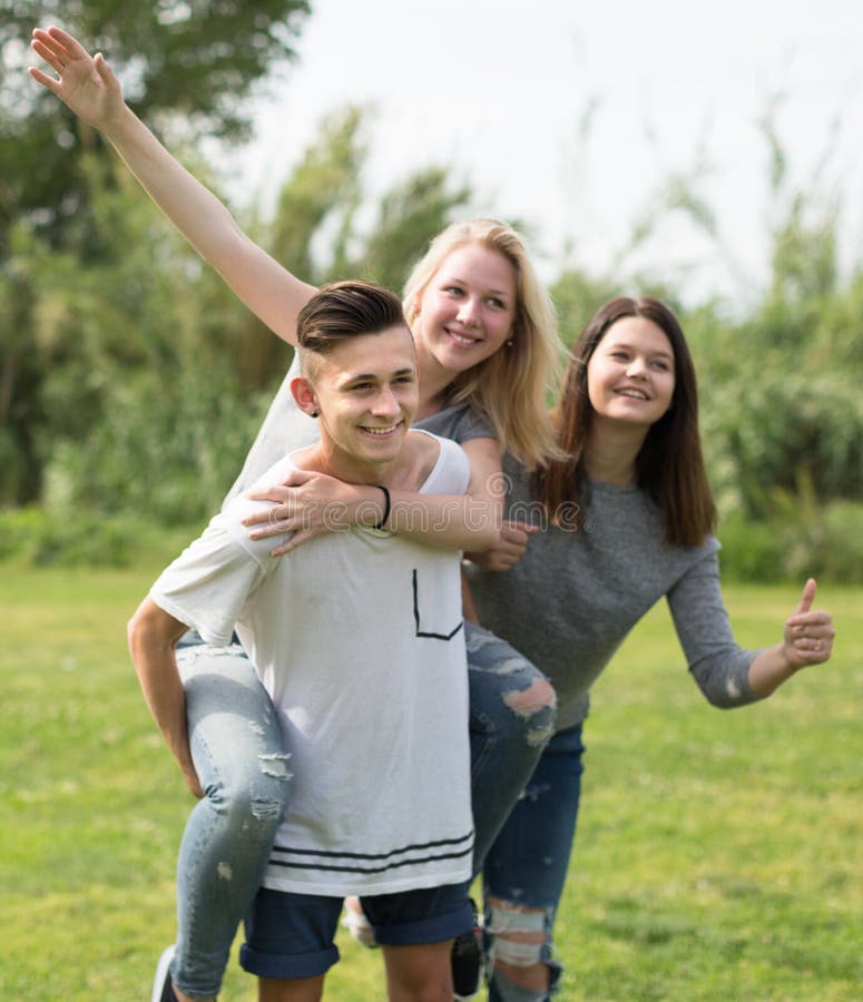 Adolescentes que corren a través de césped verde en verano en parque imagen de archivo libre de regalías Adolescentes que corren a través de césped verde en verano en parque imagen de archivo libre de regalías