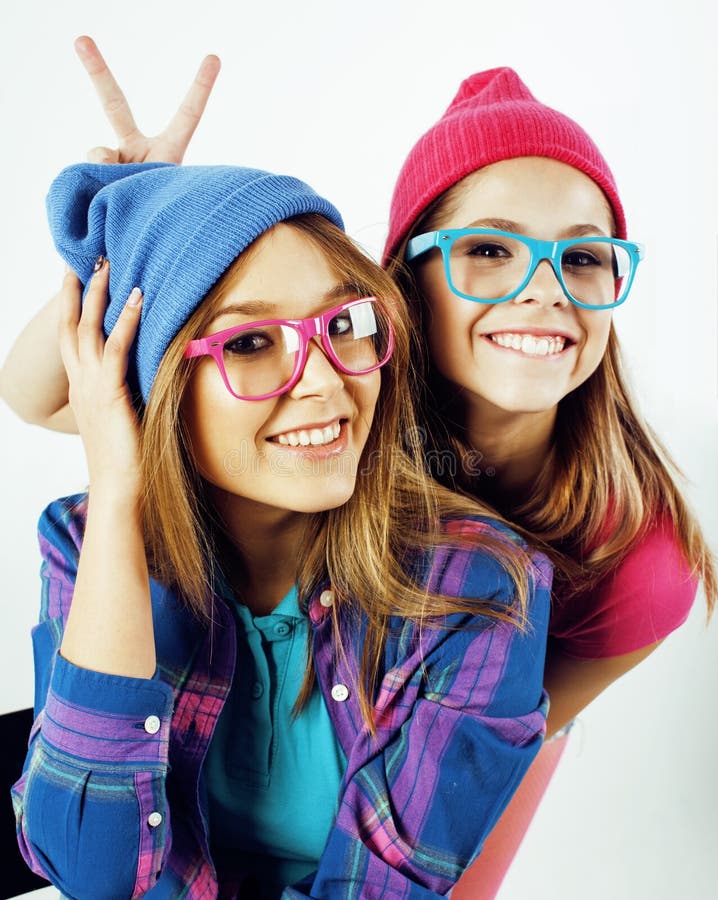 Best friends teenage girls together having fun, posing emotional on white background, besties happy smiling, lifestyle real people concept close up. making selfie. Best friends teenage girls together having fun, posing emotional on white background, besties happy smiling, lifestyle real people concept close up. making selfie