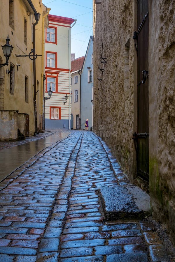 Wet cobblestones after rain on a narrow street in the old town of Tallinn, Estonia. Cozy street in Tallinn. Wet cobblestones after rain on a narrow street in the old town of Tallinn, Estonia. Cozy street in Tallinn.