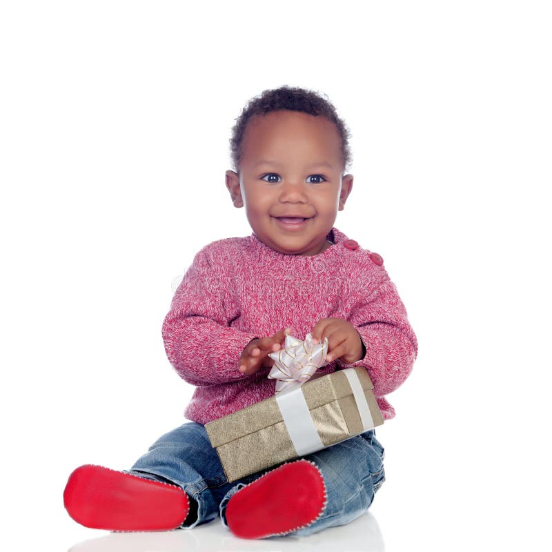 Adorable African American child playing with a gift box