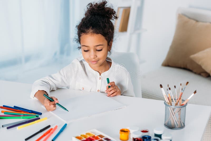 adorable african american kid drawing with felt pens
