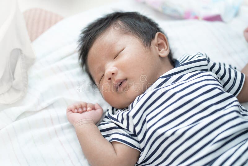 Adorable Asian sleeping, tiny infant healthy sleep with warm wool white blanket at home, baby health care concept. royalty free stock photography Adorable Asian sleeping, tiny infant healthy sleep with warm wool white blanket at home, baby health care concept. royalty free stock photography