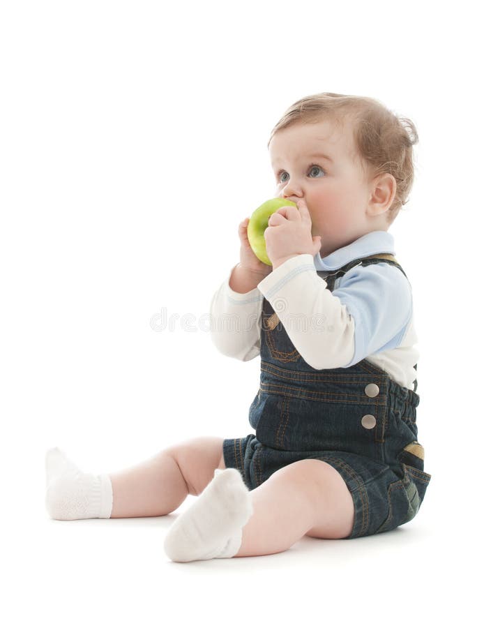 Adorable baby boy sit and eat green apple