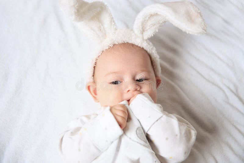 A Cute Baby in a Bunny Suit Lies on the Straw Stock Image - Image of ...