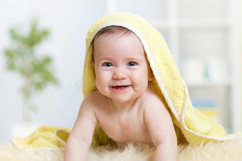 Adorable baby child under bathing towel indoor stock photography Adorable baby child under bathing towel indoor stock photography
