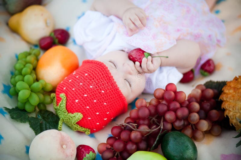 Adorable baby girl in the fruits