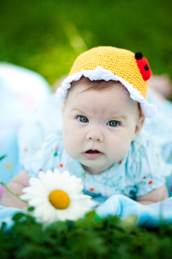 Adorable baby girl outdoors in the grass