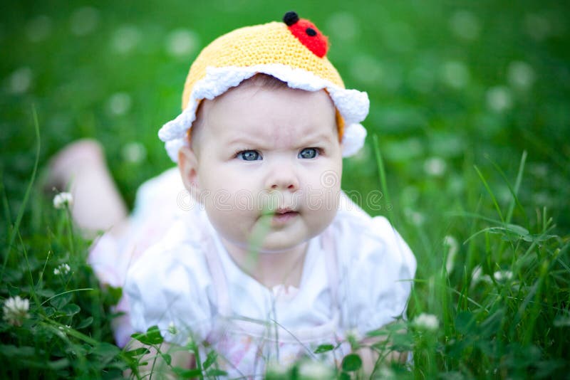 Adorable baby girl outdoors in the grass