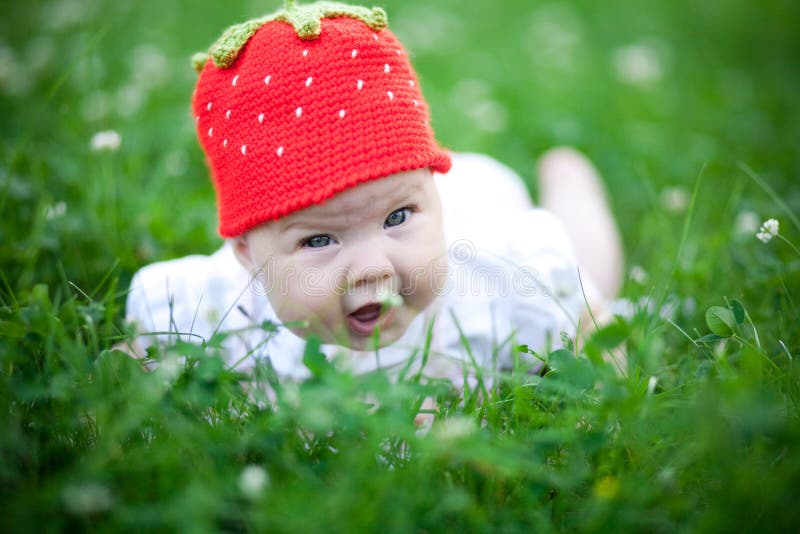 Adorable baby girl outdoors in the grass