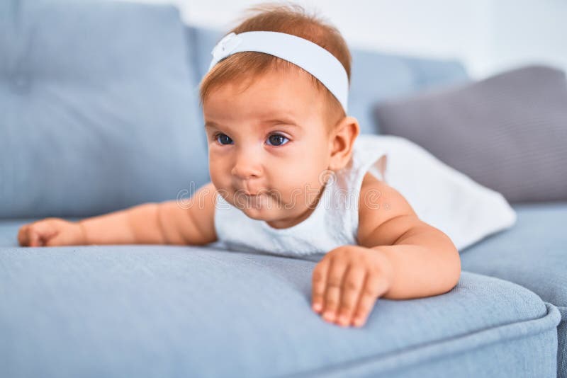 Adorable Baby Lying Down On The Sofa At Home Stock Photo Image Of