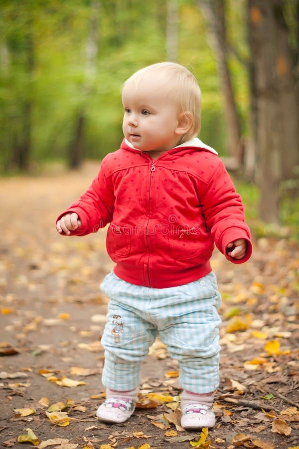 Adorable baby walk by road in park