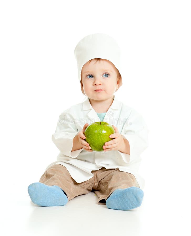 Adorable boy uniformed as doctor with green apple