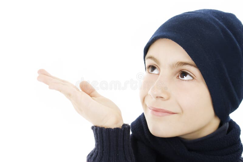 Adorable boy in winter clothes. Checks to see if it is snowing. Winter woolen clothes stock images, royalty-free photos and pictures