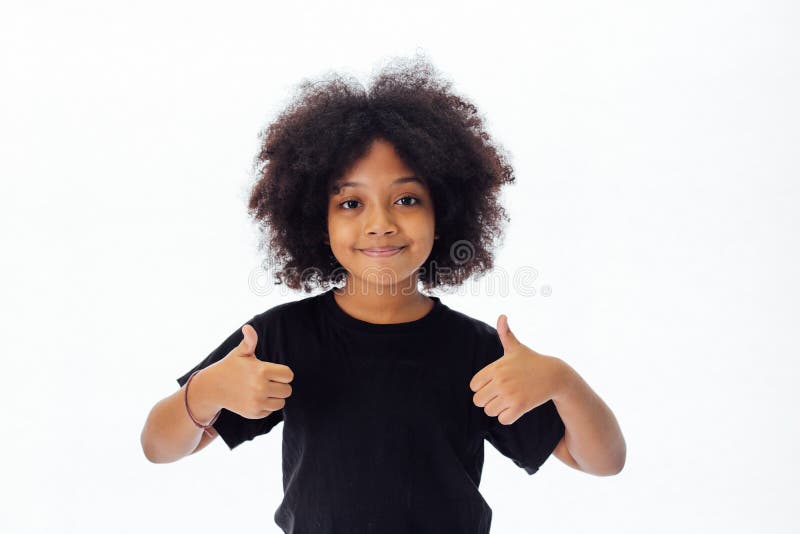 Adorable and cheerful African American kid with afro hairstyle giving thumbs up
