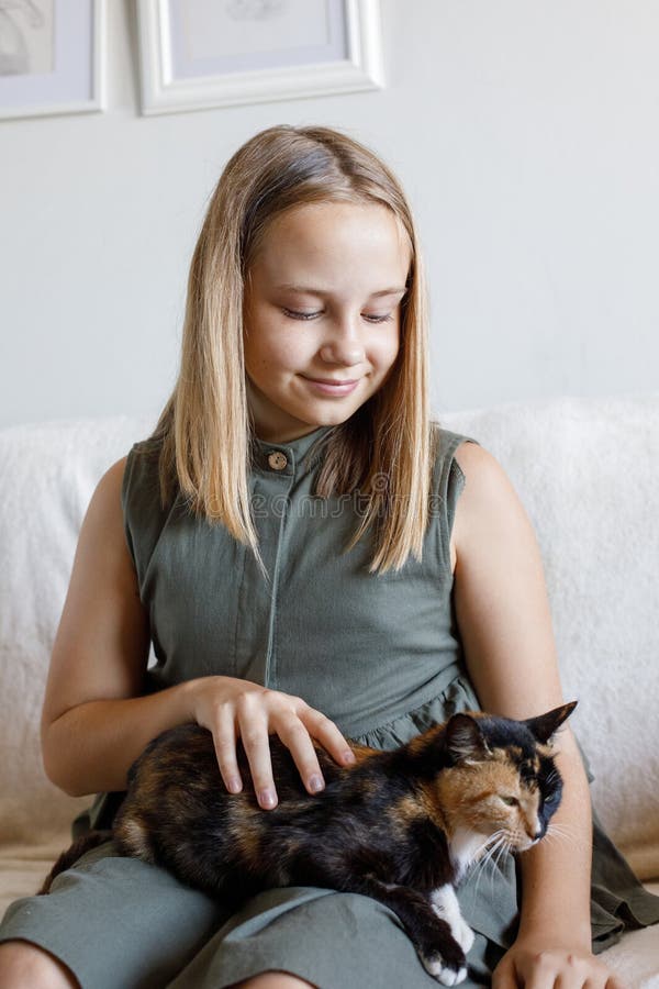 Adorable child and her cat pet at home royalty free stock images