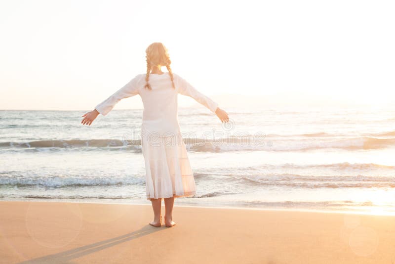 Adorable Child Little Girl Looks at the Sky and Sea stock photography Adorable Child Little Girl Looks at the Sky and Sea stock photography