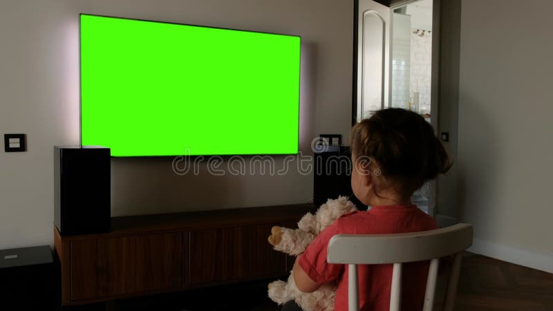 Child in front of a green screen TV