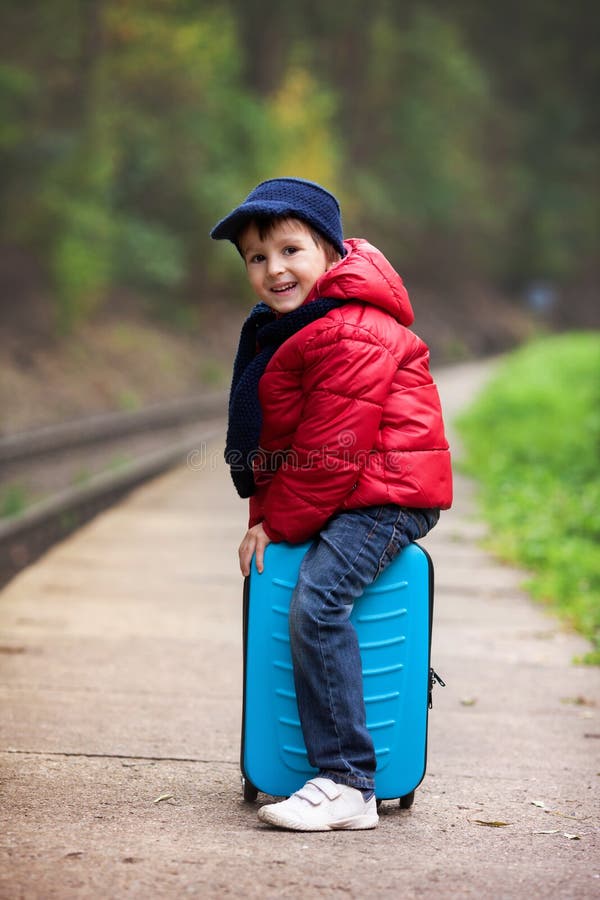 Adorable cute little child, boy, waiting on a railway station fo royalty free stock images Adorable cute little child, boy, waiting on a railway station fo royalty free stock images