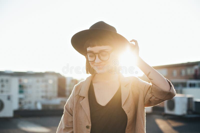 Adorable cute woman in fedora hat at sunset stock photos Adorable cute woman in fedora hat at sunset stock photos