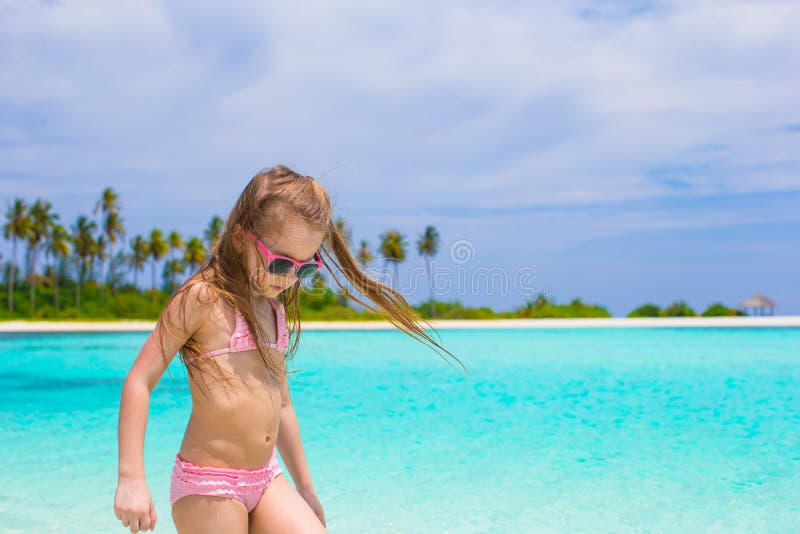 Adorable happy little girl have fun at shallow