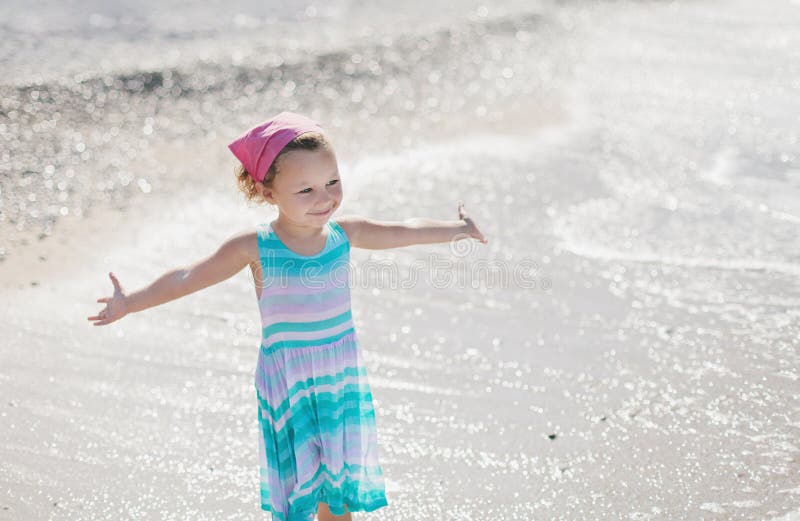 Adorable Happy Smiling Little Girl with Curly Hair on Beach Vacation ...