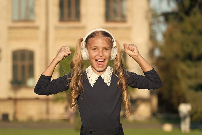 Adorable kid using modern technology. Modern child. Perfect sound. Expand opportunities. Inspired by music. Girl. Listening music modern gadget. Cute kid with royalty free stock image Adorable kid using modern technology. Modern child. Perfect sound. Expand opportunities. Inspired by music. Girl. Listening music modern gadget. Cute kid with royalty free stock image