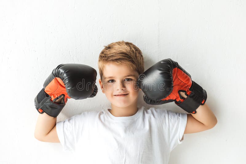 adorable little boy in boxing gloves smiling at camera stock images adorable little boy in boxing gloves smiling at camera stock images