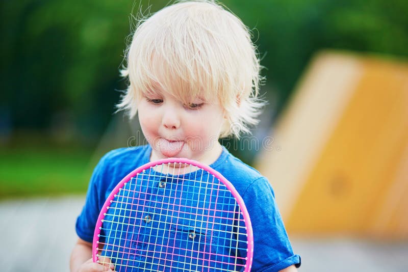 Little boy playing badminton with mom on the playground royalty free stock photo Little boy playing badminton with mom on the playground royalty free stock photo