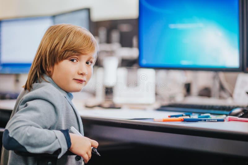 Adorable little boy visiting parents working place, educational program for children