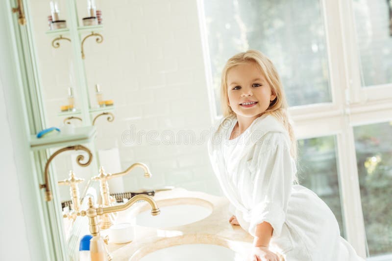 little girl on bathroom sink