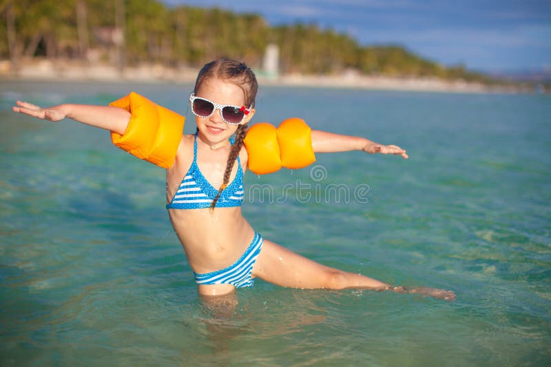 Adorable little girl have fun in the sea on