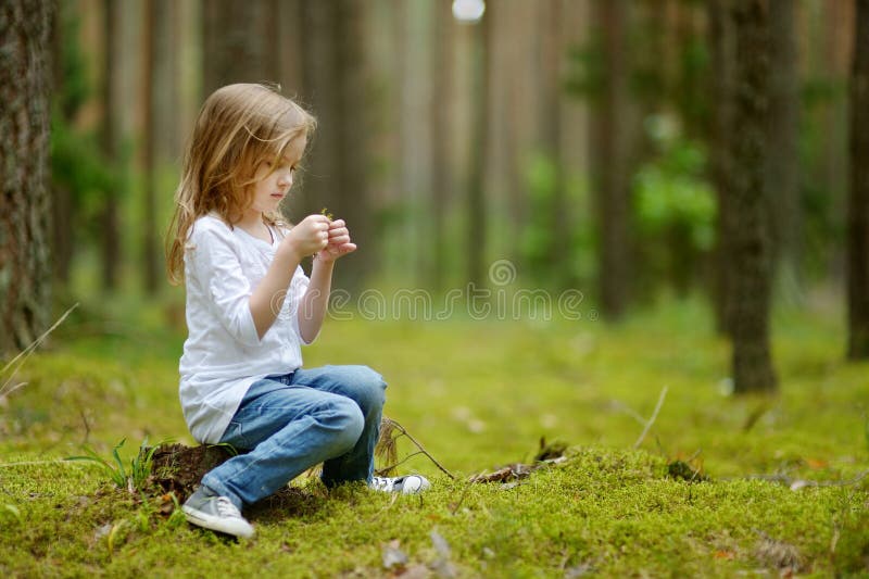 Adorable little girl hiking in the forest
