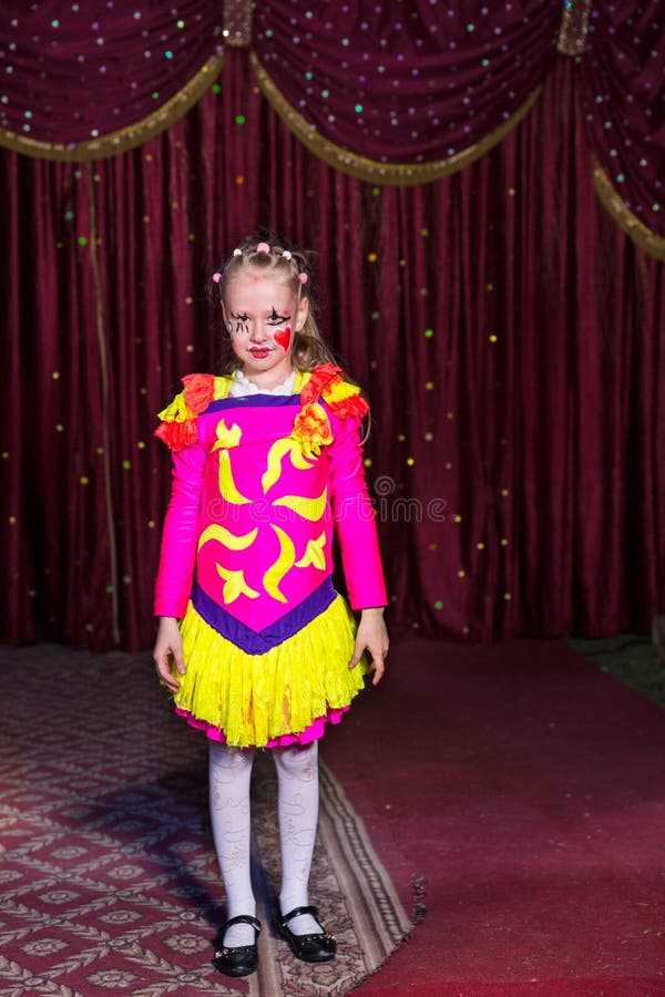 Adorable little girl in a pink and yellow costume