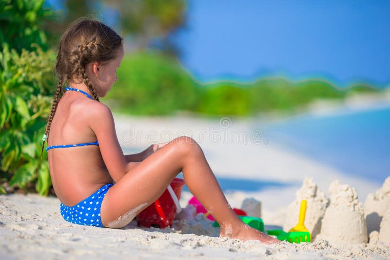 Adorable little girl playing with beach toys