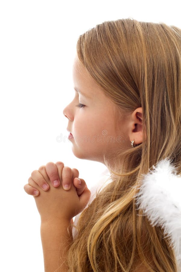 Adorable little girl praying peacefully - isolated, closeup