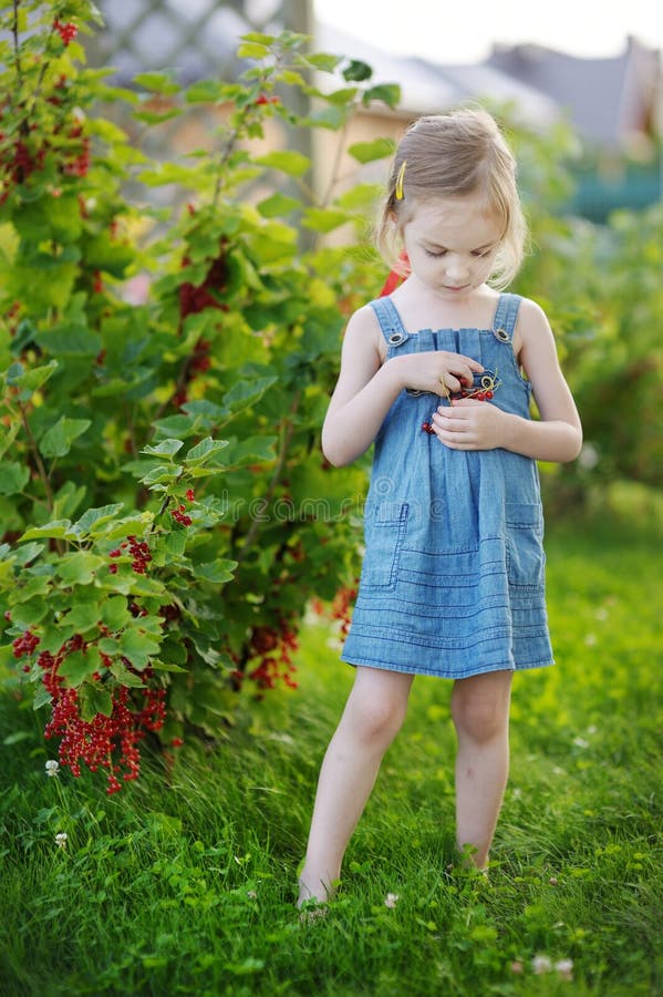 Adorable little girl with red currants