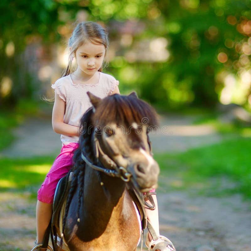 Adorable Little Girl Riding a Pony Stock Photo - Image of lifestyle ...