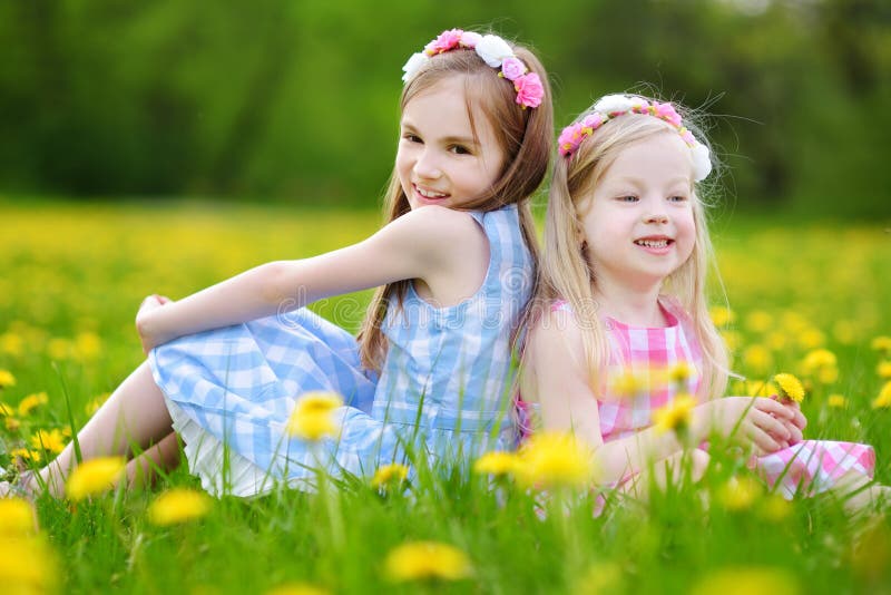 Adorable Little Girls Wearing Wreaths in Blooming Dandelion Meadow on ...