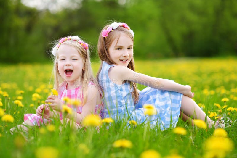 Adorable Little Girls Wearing Wreaths in Blooming Dandelion Meadow on ...