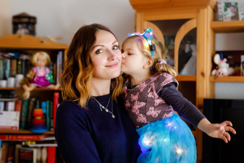 Adorable little toddler girl with beautiful young mother. Happy healthy family portrait, mom love and happiness, hugging royalty free stock photography Adorable little toddler girl with beautiful young mother. Happy healthy family portrait, mom love and happiness, hugging royalty free stock photography