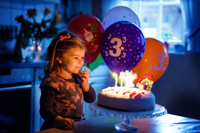 Adorable little toddler girl celebrating third birthday. Baby toddler child with homemade unicorn cake, indoor. Happy stock photography Adorable little toddler girl celebrating third birthday. Baby toddler child with homemade unicorn cake, indoor. Happy stock photography