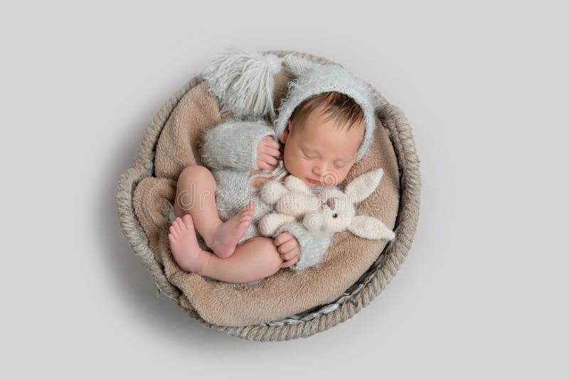 Top view of newborn baby boy laying in a bowl