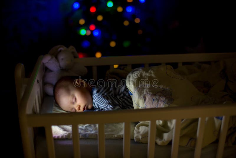 Adorable newborn baby boy, sleeping in crib at night royalty free stock photography Adorable newborn baby boy, sleeping in crib at night royalty free stock photography