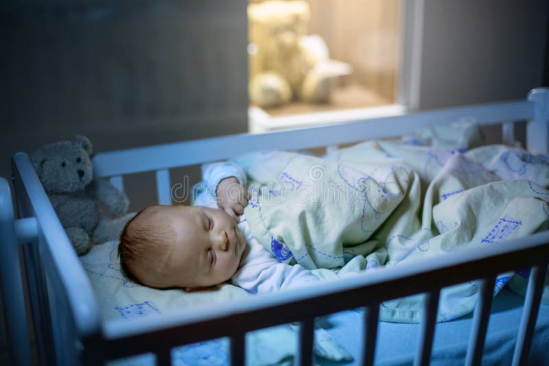 Adorable newborn baby boy, sleeping in crib at night royalty free stock photography Adorable newborn baby boy, sleeping in crib at night royalty free stock photography