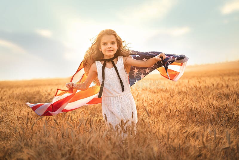 Adorable patriotic girl in white dress wearing an American flag