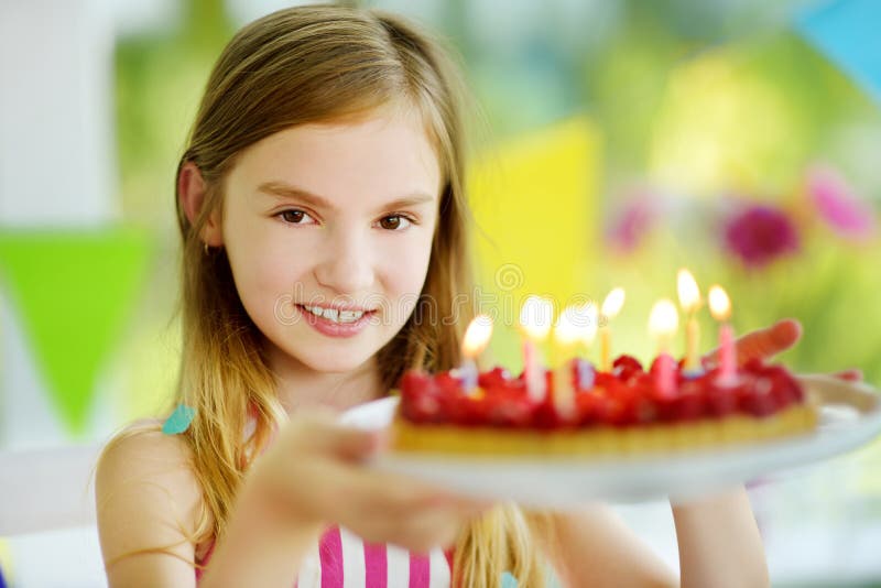 Adorable preteen girl having birthday party at home, blowing candles on birthday cake royalty free stock photography Adorable preteen girl having birthday party at home, blowing candles on birthday cake royalty free stock photography