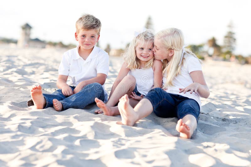 Adorable Sisters and Brother Having Fun at the Beach